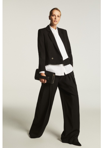 Wide black trousers with a box pleat