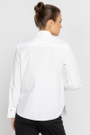 White blouse with a pleat transitioning into a tie 