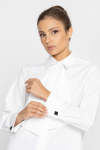 White blouse with a pleat transitioning into a tie 