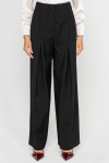 Wide black trousers with a box pleat