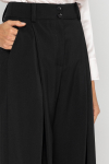 Wide black trousers with a box pleat