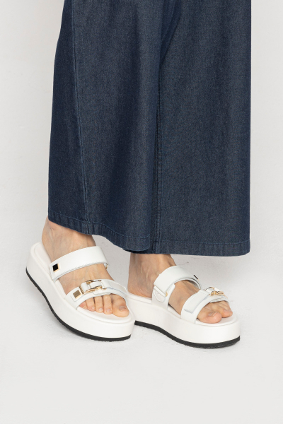 Modern white flip-flops on thick soles 